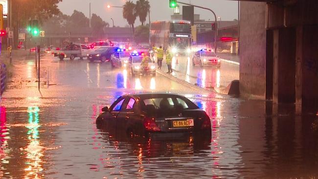 A P-Plate becomes stranded by the deep water on Woodville Rd, Granville. Picture: TNV