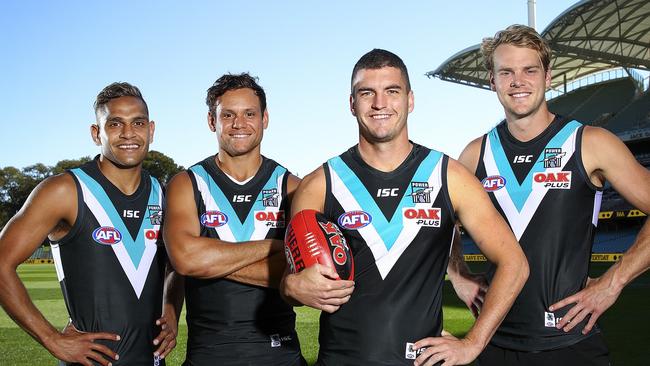 Port Adelaide recruits, Dom Barry, Steven Motlop, Tom Rockliff and Jack Watts, ahead of their first AFL game for the Power in March 2018. Picture: Sarah Reed