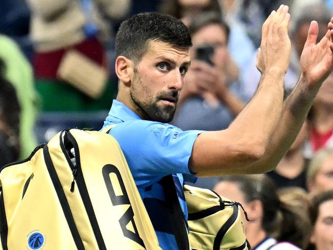 Serbia's Novak Djokovic waves at the crowd after his defeat against Australia's Alexei Popyrin during their men's singles third round match on day five of the US Open tennis tournament at the USTA Billie Jean King National Tennis Center in New York City, on August 30, 2024. (Photo by ANGELA WEISS / AFP)