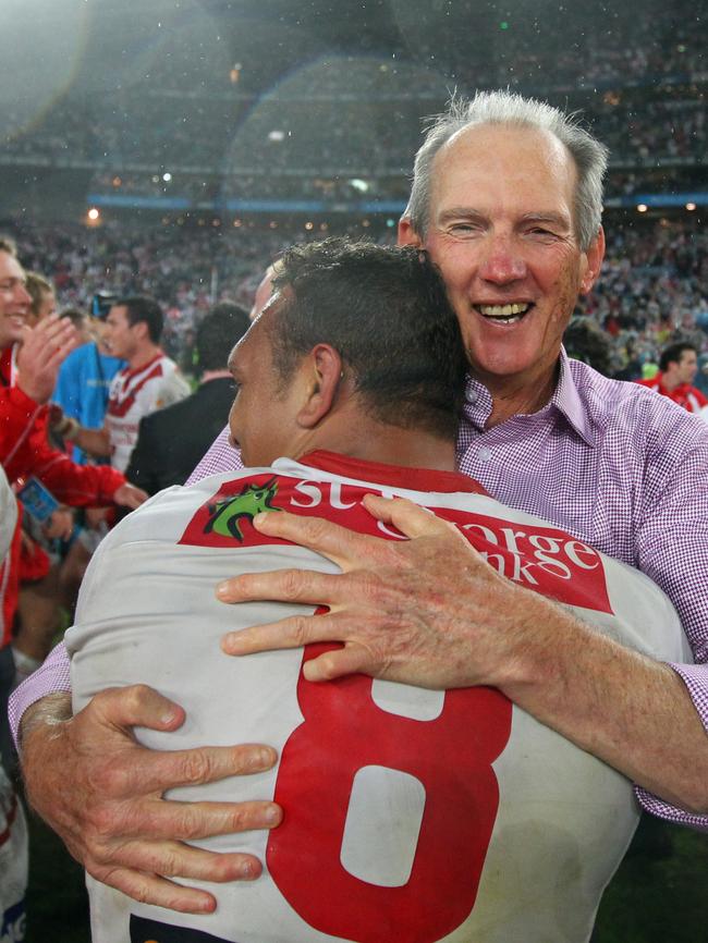 Coach Wayne Bennett hugs player Neville Costigan after the St George Illawarra Dragons defeated the Sydney Roosters in the 2010 grand final.