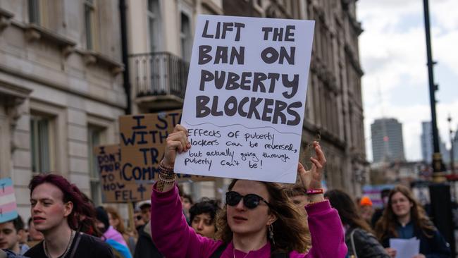 Trans rights activists take part in a protest against the ban on hormone blockers in London. Picture: Getty Images