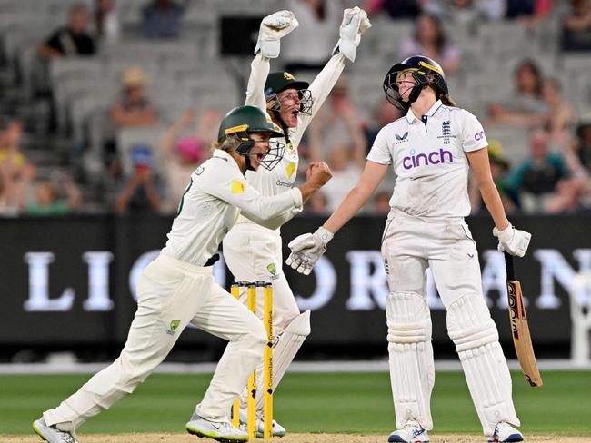 The agony and ecstasy: Australia’s Phoebe Litchfield, left, and Beth Mooney celebrate the fall of the last England wicket, Lauren Filer, right, as the tourists are whitewashed in the multi-format series Picture: AFP