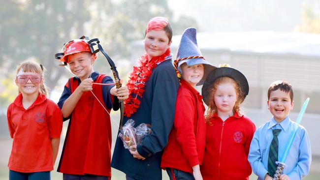 HILLS SHIRE TIMES/AAP. (L-R) Murray Farm students Cara Turco 8, Leo Turco 10, Gerred Sherwood 11, Olivia Jefferies 8, Caitlin Jefferies 5 and Declan Sherwood 6 pose for photographs in Carlingford. Carlingford, Friday 24 May, 2019. Students celebrating the return of the Murray Farm Cracker Carnival. (AAP IMAGE / Angelo Velardo)