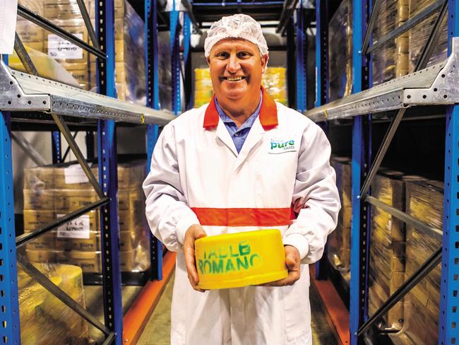 Beston Global Food Company's master cheesemaker Paul Connolly with a wheel of romano cheese. Pic: Beston