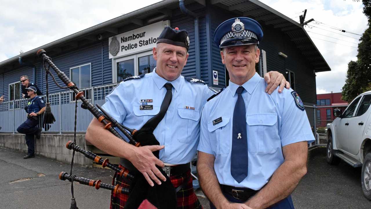 SHIFT OVER: Retiring police officer Sergeant Bruce Maclean (right) is embraced on his last day of work by his younger brother Sergeant Neil Maclean. Picture: Stuart Cumming