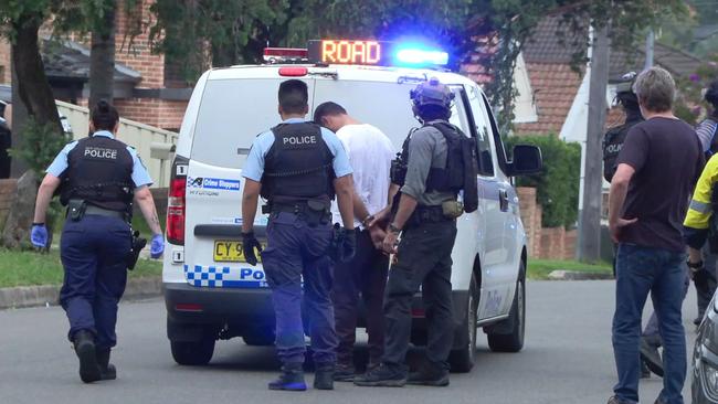 NSW Police arrest a man after storming a home in Belmore. Picture: News Media Network