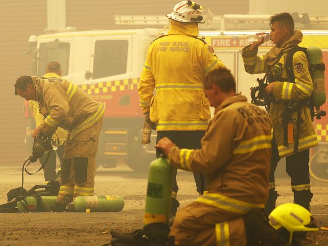 Exhausted fire fighters battling to save Balmoral take a quick break before returning to the fire front. Picture: Sam Ruttyn