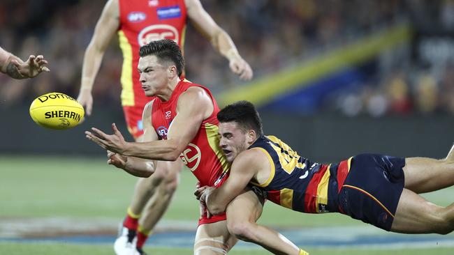 Gold Coast’s Ben Ainsworth is tackled by Adeaide’s Lachlan Murphy. Picture: Sarah Reed