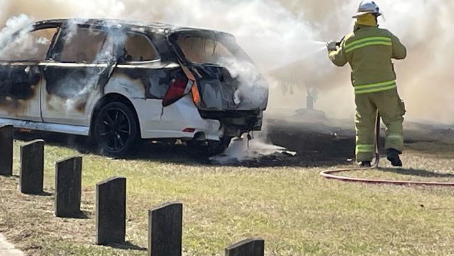 Fire crews work to douse the flames after a fiery crash in Archerfield.