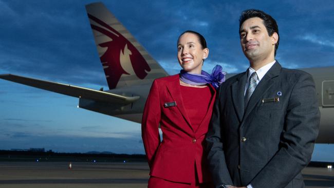 BRISBANE, AUSTRALIA - DECEMBER 04: In this image released on December 12, crew from both Virgin Australia and Qatar Airways beside a Qatar Airways Boeing 777 at Brisbane Airport on December 04, 2024 in Brisbane, Australia. A new partnership between the two airlines has been launched which will deliver more value and choice to Australians, providing opportunities to travel to over 100 destinations across Europe, the Middle East and Africa. From December 12, Aussies can book Virgin Australia's new direct services from Sydney, Brisbane and Perth to Doha for travel from June 2025, with Melbourne set to launch later in 2025. These flights will be operated by Virgin Australia using Qatar Airways' spacious Boeing 777s, renowned for their Qsuite Business Class. (Photo by James D. Morgan/Getty Images for Virgin Australia)