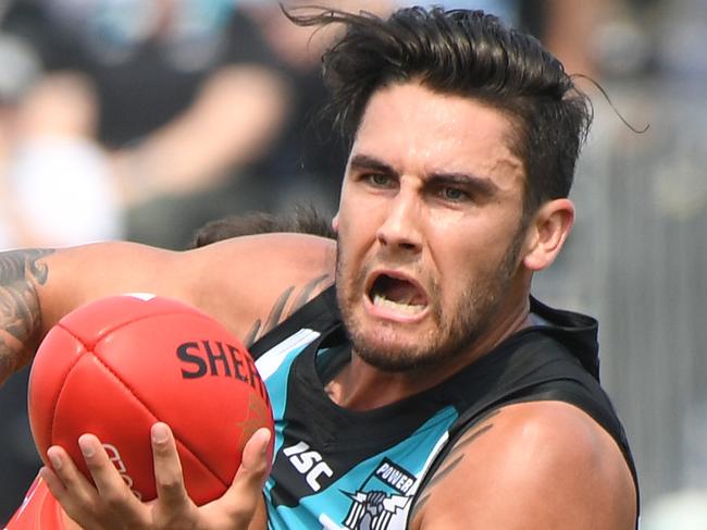 Chad Wingard of the Power passes as he is tackled by Jack Martin of the Suns during the round 8 AFL match between the Gold Coast Suns and the Port Adelaide Power at Jiangwan Stadium in Shanghai, China, Sunday, May 14, 2017. (AAP Image/Tracey Nearmy) NO ARCHIVING, EDITORIAL ONLY