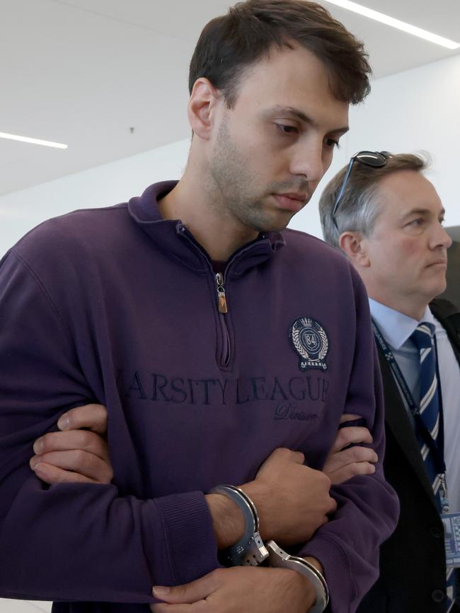 Accused attempted murderer Zacharia Josef Bruckner arrives at the Adelaide Airport with police after being extradited from Queensland. Picture: NCA NewsWire / Kelly Barnes