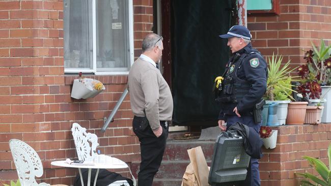 Strike Force Childowla detectives conduct a search warrant at the Pitt Street, Stockton, address where a 22-year-old man was arrested over the death of Graham Cameron. Picture by Peter Lorimer.