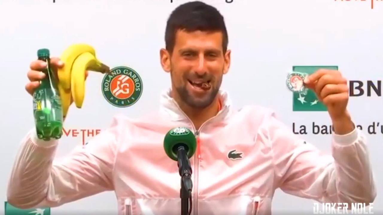 Novak Djokovic holds his gifts aloft during a French Open press conference. Photo: Twitter