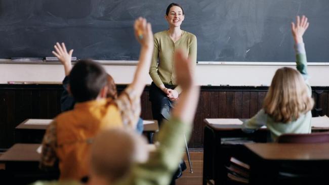 NEWS: Generic pic of a teacher standing at the blackboard while talking to students in a classroom.