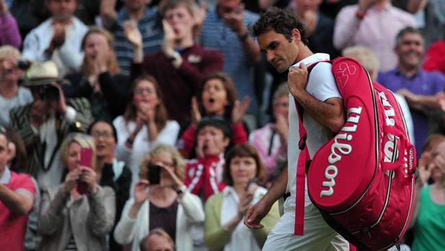 Roger Federer walks off centre court after being beaten by 's Sergiy Stakhovsky during their second round men's singles match on day three of the 2013 Wimbledon tournament in London. Picture: AFP