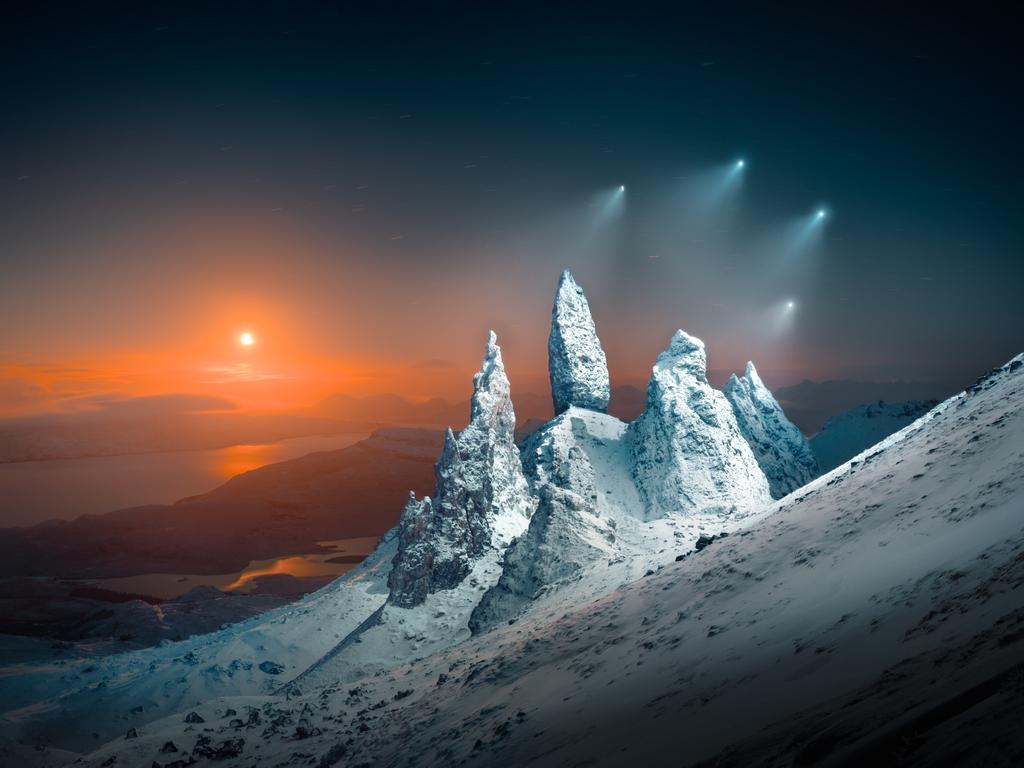 Moonrise and drone lights reveal Scotland’s Old Man of Storr, showcasing the icy terrain amid a powerful blizzard. Picture: Liam Man