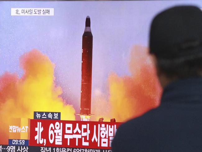 FILE - In this Oct. 16, 2016, file photo, a man watches a TV news program showing a file image of a missile launch conducted by North Korea, at the Seoul Railway Station in Seoul, South Korea. North Korea now has the capability to launch a nuclear weapon, a senior U.S. military official said Dec. 8, adding that while the U.S. believes Pyongyang can mount a warhead on a missile, it's not clear that it can hit a target. (AP Photo/Ahn Young-joon, File)