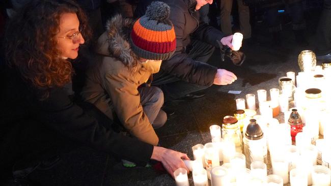 Warsaw residents light candles to commemorate deaths from Covid-19. Picture: AFP