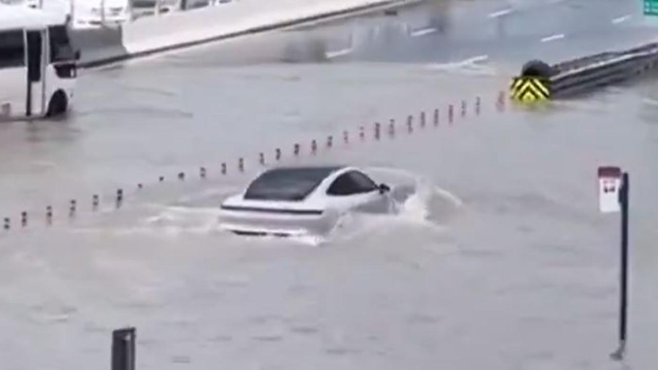 A Porsche making its way through flood waters. Picture: X/Twitter.