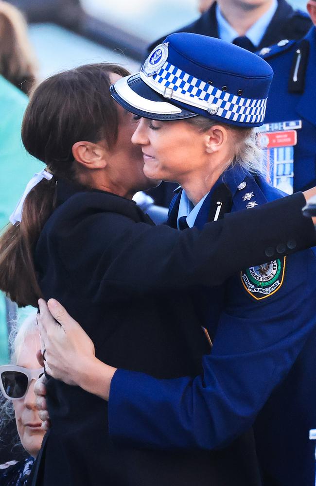 Amy Scott, the brave police officer who shot down the Bondi Junction attacker, is hugged during a candlelight vigil to honour the victims of the massacre. Picture: Jenny Evans/Getty Images