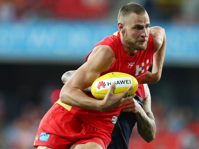 Jarrod Witts and the Suns in is tackled during the round eight AFL match between the Gold Coast Suns and the Melbourne Demons at Metricon Stadium on May 11, 2019 in Gold Coast, Australia. (Photo by Chris Hyde/Getty Images)