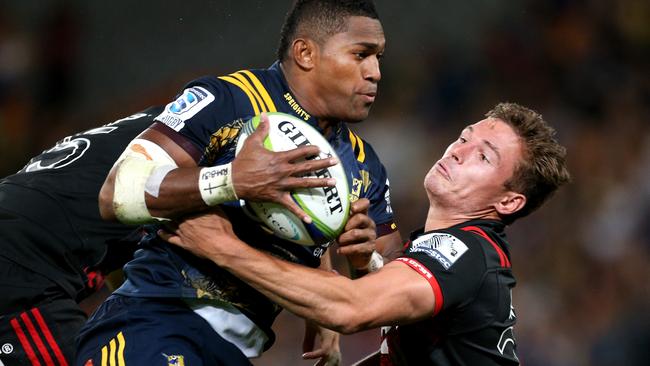 DUNEDIN, NEW ZEALAND — MARCH 04: Waisake Naholo (L) of the Highlanders and George Bridge of the Crusaders compete for the high ball during the round two Super Rugby match between the Highlanders and the Crusaders at Forsyth Barr Stadium on March 4, 2017 in Dunedin, New Zealand. (Photo by Dianne Manson/Getty Images)