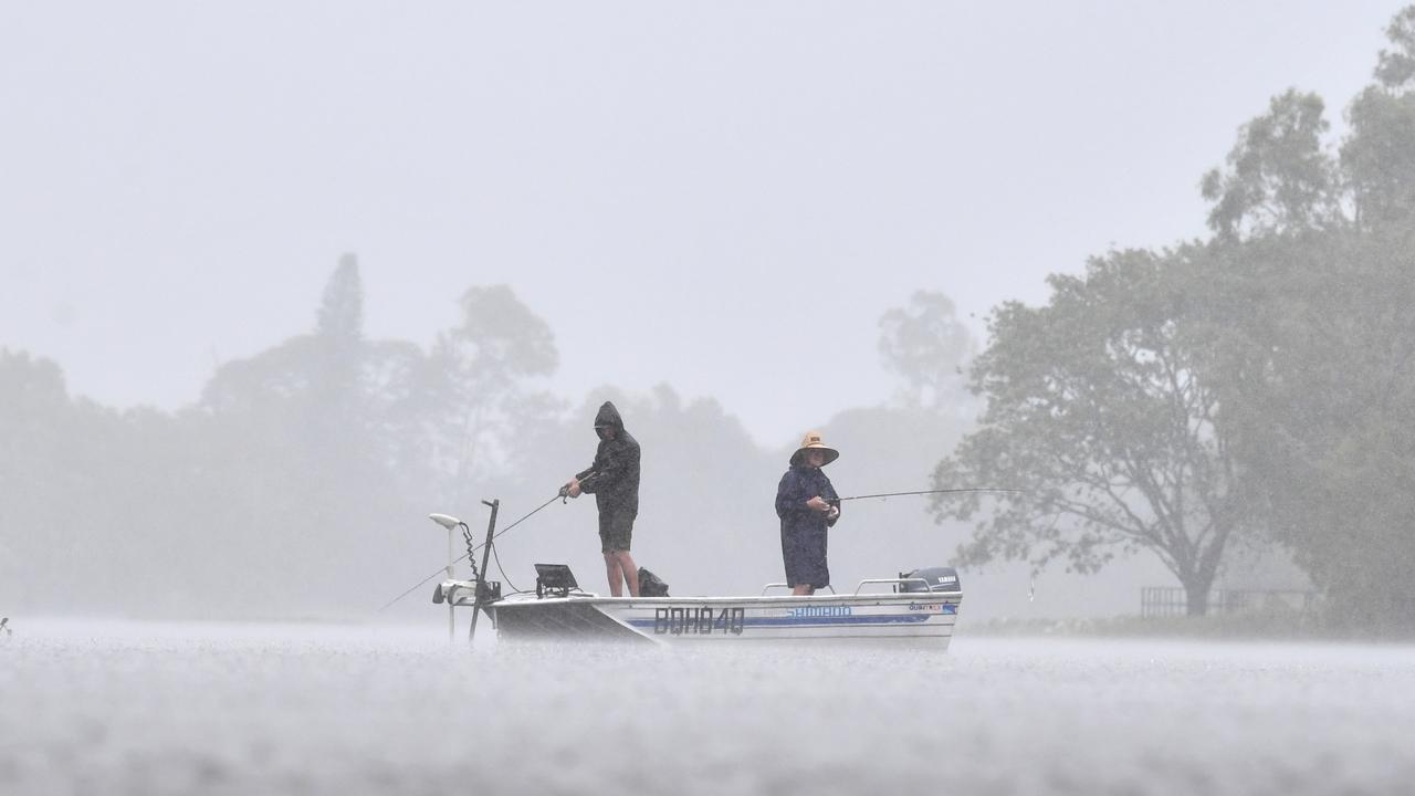 Wet weather in Townsville. Heavy rain does not stop fishing at Applins Weir. Picture: Evan Morgan