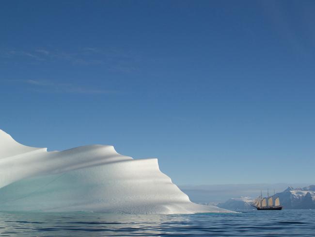 Sailing in Meringue ... Capturing the immensity of the landscape in Greenland is difficult. The sky is huge, the mountains are gigantic and the icebergs are colossal. When our zodiac rounded this beautiful iceberg, our sailing ship was in the background, giving some sense of scale to this whipped iceberg. Picture: Philip Friedman/2016 National Geographic Nature Photographer of the Year