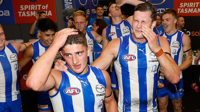 MELBOURNE, AUSTRALIA - MARCH 18: Harry Sheezel (left) and Charlie Comben of the Kangaroos sing the team song during the 2023 AFL Round 01 match between the North Melbourne Kangaroos and the West Coast Eagles at Marvel Stadium on March 18, 2023 in Melbourne, Australia. (Photo by Michael Willson/AFL Photos via Getty Images)