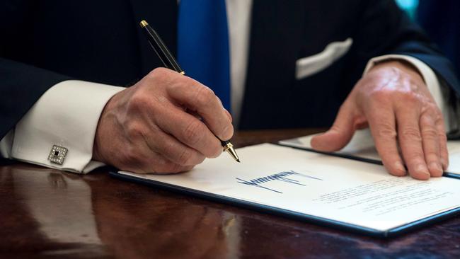 There it is, Trump’s angular signature which shows he craves power but is also a ‘big hunk of a man’. Picture: Nicholas Kamm/AFP.