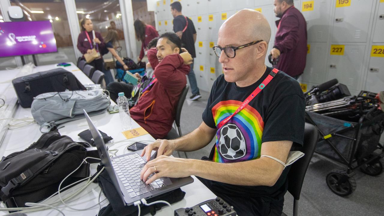 AL RAYYAN, QATAR - NOVEMBER 21: Journalist Grant Wahl (right) works in the FIFA Media Center before a FIFA World Cup Qatar 2022 Group B match between Wales and USMNT at Ahmad Bin Ali Stadium on November 21, 2022 in Al Rayyan, Qatar. He had been detained earlier by stadium security for wearing a rainbow-coloured t-shirt before later being allowed to enter the stadium. (Photo by Doug Zimmerman/ISI Photos/Getty Images)