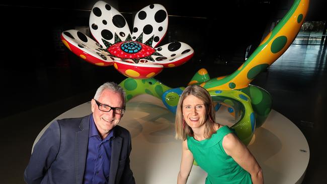 QAGOMA director Chris Saines and philanthropy manager Dominique Jones with Yayoi Kusama’s sculpture Flowers that bloom at midnight purchased with the help of Mrs Win Schubert. Picture: Annette Dew