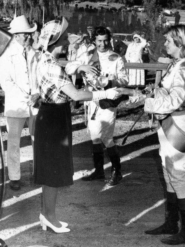 Jockeys Phil Oates and Sharon Conway are presented to the Queen after their exhibition quarter horse race at Willomurra Stud, Kersbrook.