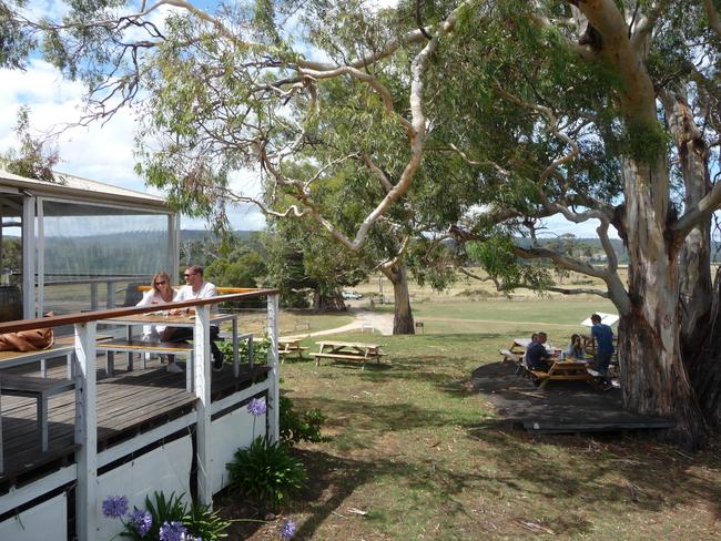 Diners on the deck and under a giant gum tree by the dam at Sophie's at Milton. Picture: LIBBY SUTHERLAND