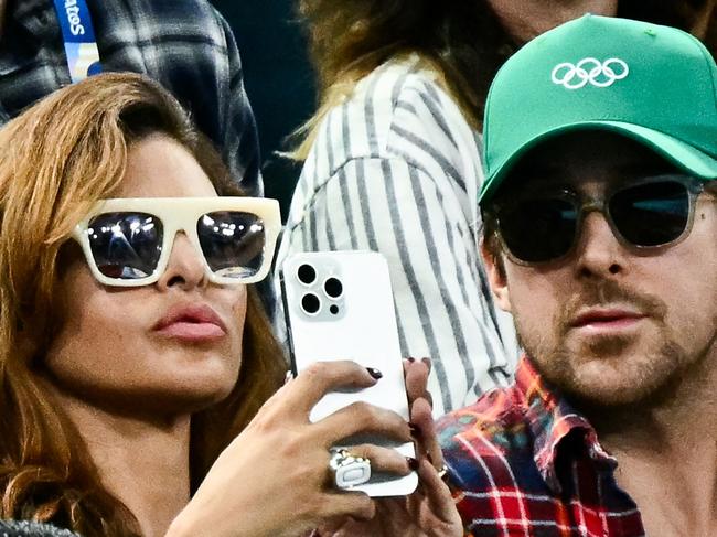 US actress Eva Mendes (L) and her partner Canadian actor Ryan Gosling (R) attend the artistic gymnastics women's uneven bars final during the Paris 2024 Olympic Games at the Bercy Arena in Paris, on August 4, 2024. (Photo by Loic VENANCE / AFP)