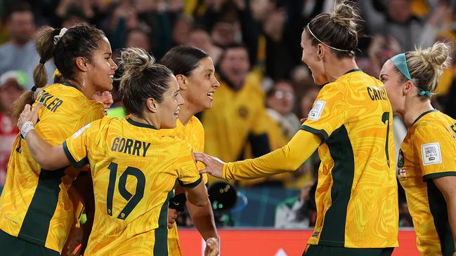 Sam Kerr celebrates with teammates after scoring against England at Stadium Australia. Picture: Getty Images