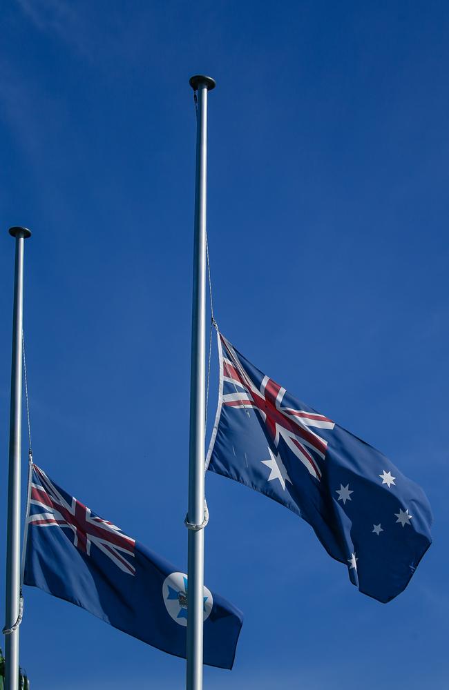 Flags are lowered outside the Gold Coast Council Chambers in tribute to the victims. Picture: Glenn Campbell