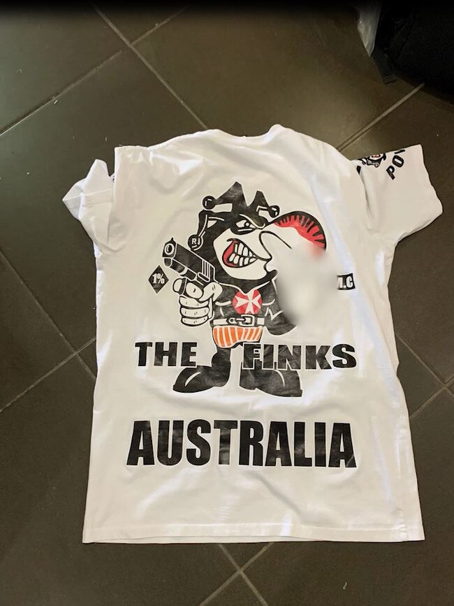 A Finks T-shirt police allegedly found at the home.