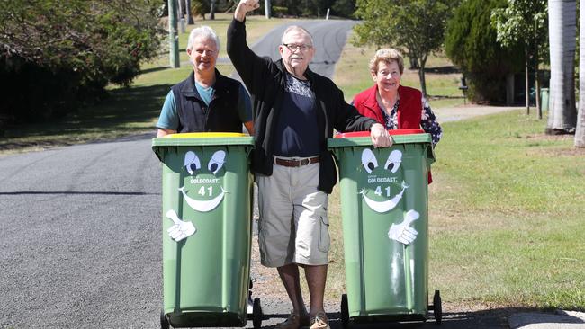 All rural areas in the Gold Coast previously without a council bin pickup service will now have one.  Local Michael Keff celebrates with Gordon Petersen (middle) and wife Marilyn Petersen. Picture Glenn Hampson