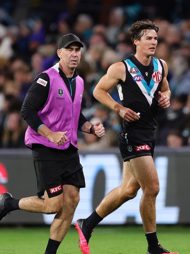 Connor Rozee heads off with a hamstring issue. Picture: Sarah Reed/AFL Photos via Getty Images