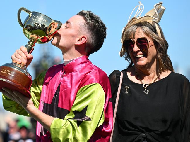 MELBOURNE, AUSTRALIA - NOVEMBER 05: Robbie Dolan kisses the trophy with trainer Sheila Laxon after Knight's Choice won Race 7, the Lexus Melbourne Cup - Betting Odds during Melbourne Cup Day at Flemington Racecourse on November 05, 2024 in Melbourne, Australia. (Photo by Vince Caligiuri/Getty Images)