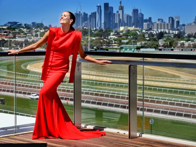 Myer Fashions on the Field Ambassador Kirsten Clemens, wearing an Alex Perry dress, available at Myer, and Cartier timepiece and Graff earrings from Kennedy, soaks in the sun on Flemington’s new Club Stand roof garden. Picture: Tony Gough