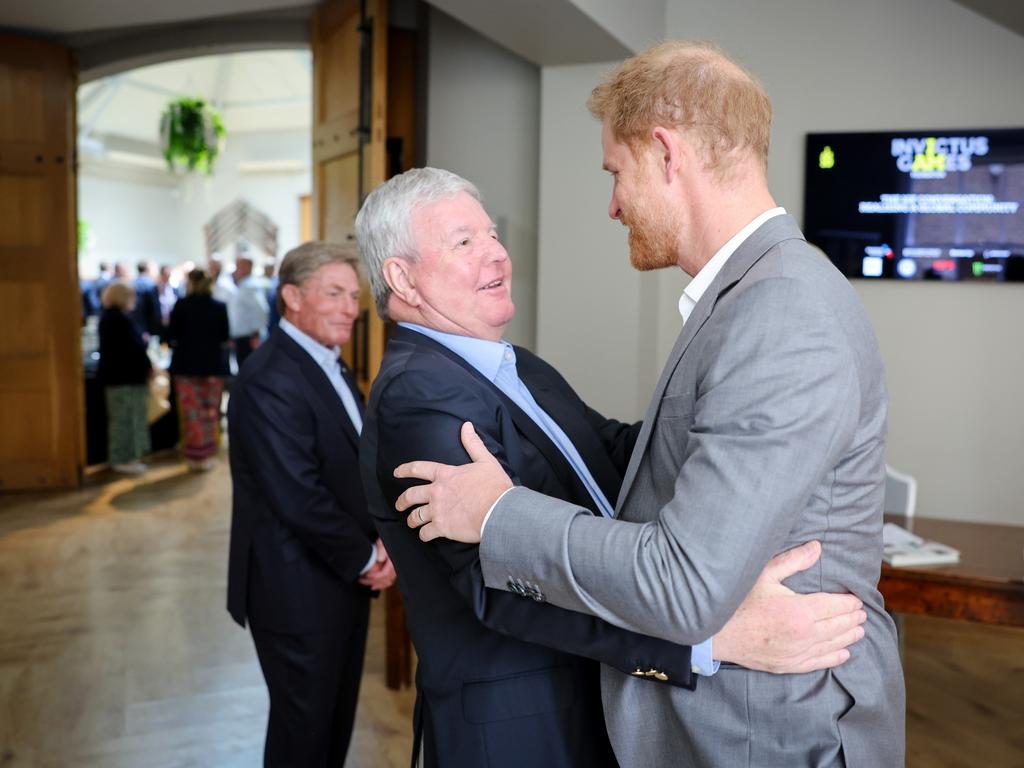 Sir Keith Mills hugs Prince Harry at the event. Picture: Getty Images