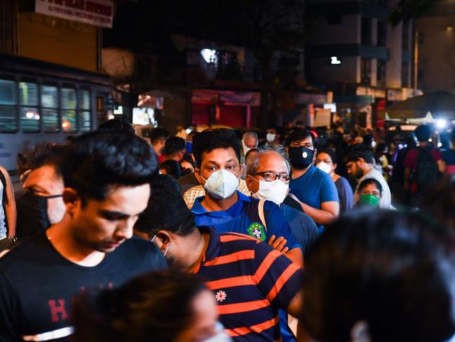 People in Mumbai line up to buy groceries as the country begins a 21-day lockdown. Picture: AFP