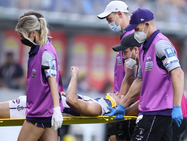 PERTH, AUSTRALIA - APRIL 03: Darcy Tucker of the Dockers is assisted off the field during the 2022 AFL Round 03 match between the West Coast Eagles and the Fremantle Dockers at Optus Stadium on April 03, 2022 In Perth, Australia. (Photo by Will Russell/AFL Photos via Getty Images)