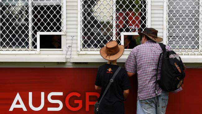 Fans talk to ticket vendors after finding out Australian Grand Prix was cancelled before practice. Picture: Getty Images