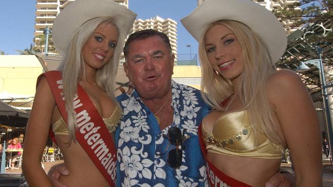 Brian ‘Shep’ Shepherd in Surfers Paradise with meter maids Sarah Godfrey 18, and Bianca Turner in 2004. Picture: Paul Riley