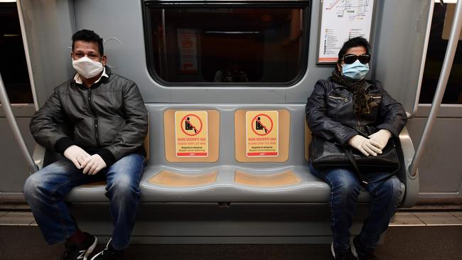 Commuters maintain social distancing in an underground metro line in Milan. Picture: AFP