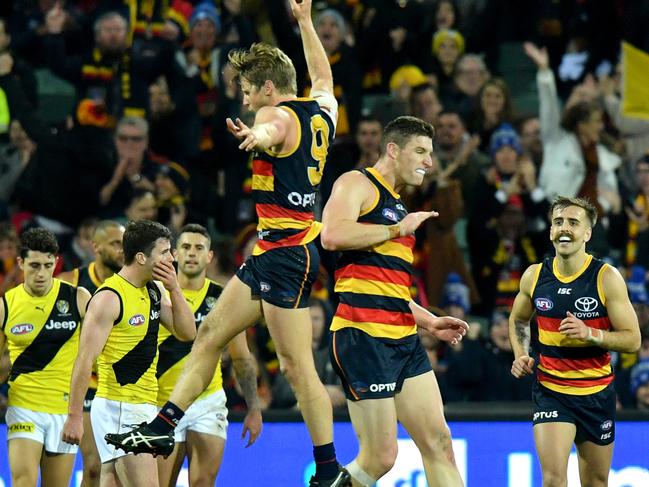 Rory Sloane of the Crows celebrates with Josh Jenkins of the Crows after Jenkins kicked a goal during the Round 13 AFL match between the Adelaide crows and the Richmond Tigers at the Adelaide Oval in Adelaide, Thursday, June 13, 2019.  (AAP Image/Sam Wundke) NO ARCHIVING, EDITORIAL USE ONLY